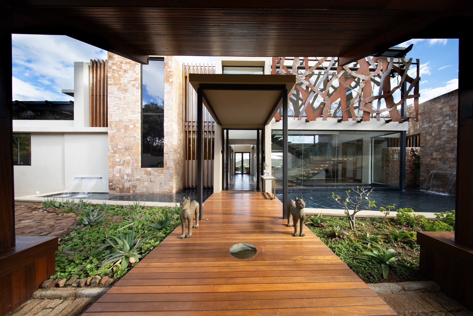 Raised timber walkway through the entrance water court of Villa Thandawena